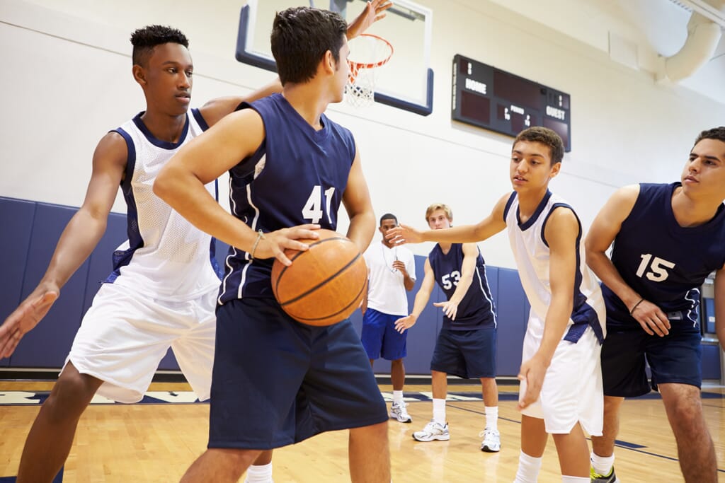 Young basketball players in action using a basketball team app