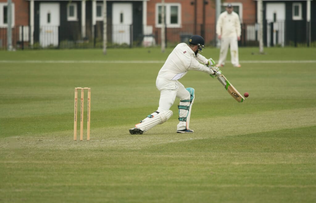 Cricket team using Spond app on smartphone in field