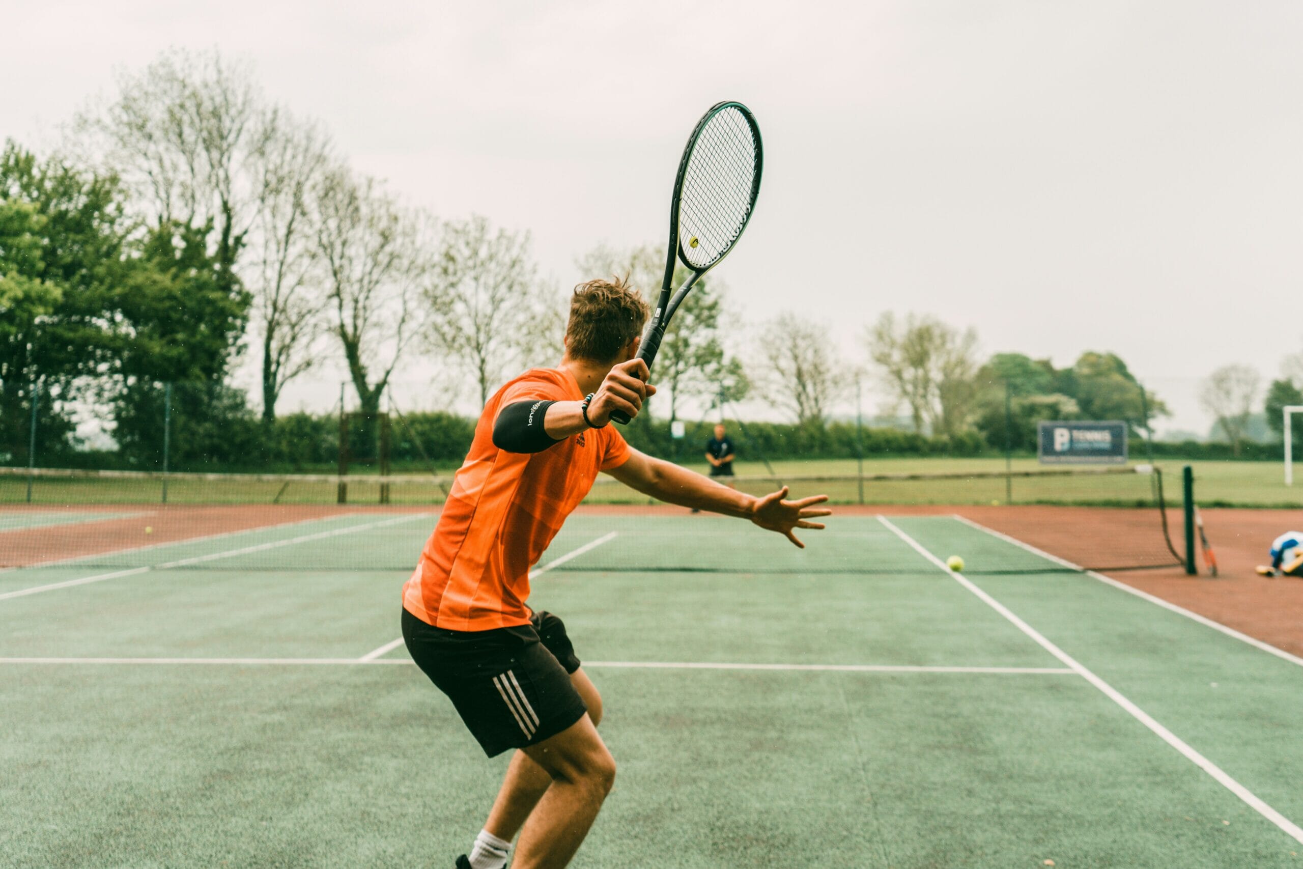 Male tennis player in action using the Spond tennis coaching app