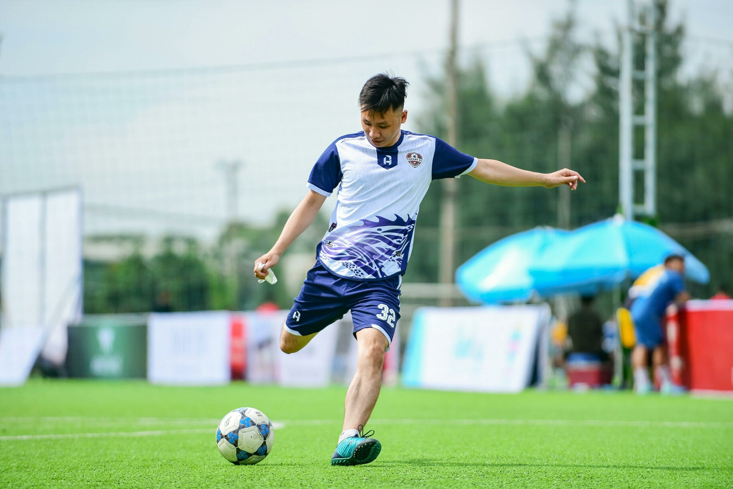 Volunteers and young footballers at a grassroots football training session using a grassroots football app