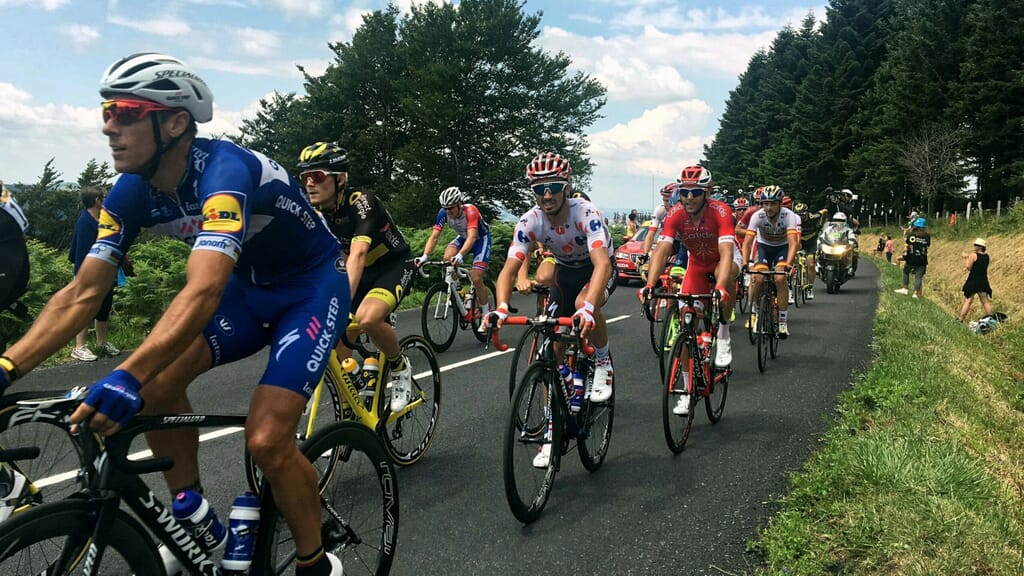 Cycling team racing on the road with the help of a cycling team app