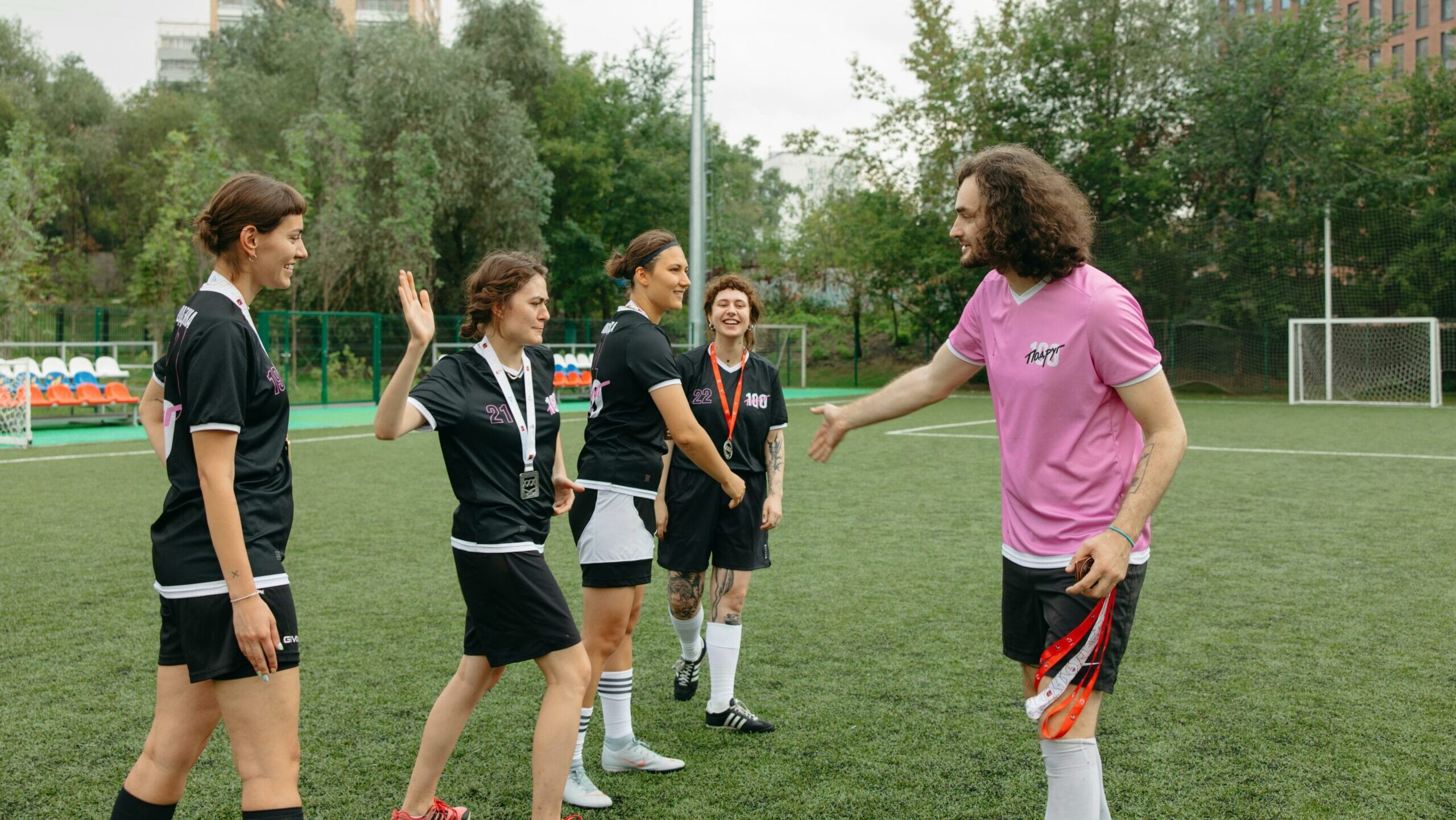 Women's football team training with coach, guide to managing in grassroots football