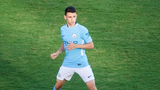 Phil Foden fishing at a serene lake, representing one of the hobbies of Premier League footballers.