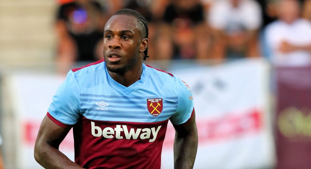 Michail Antonio reviewing real estate properties, showcasing one of the hobbies of Premier League footballers.