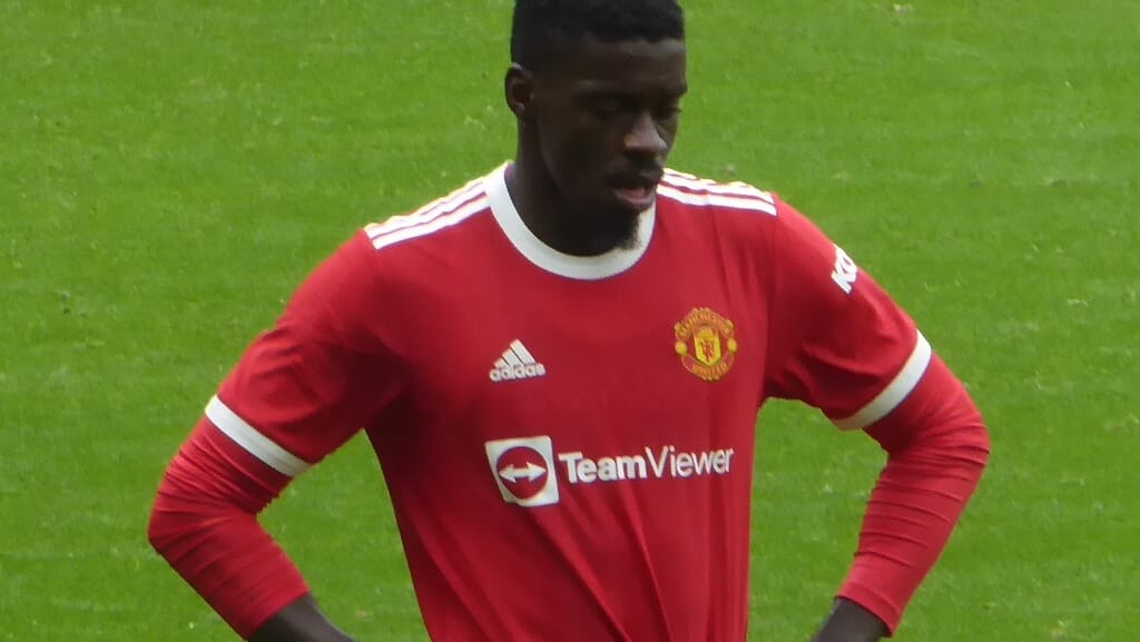 Axel Tuanzebe playing Hungry Hungry Hippos, showcasing one of the unusual hobbies of Premier League footballers.