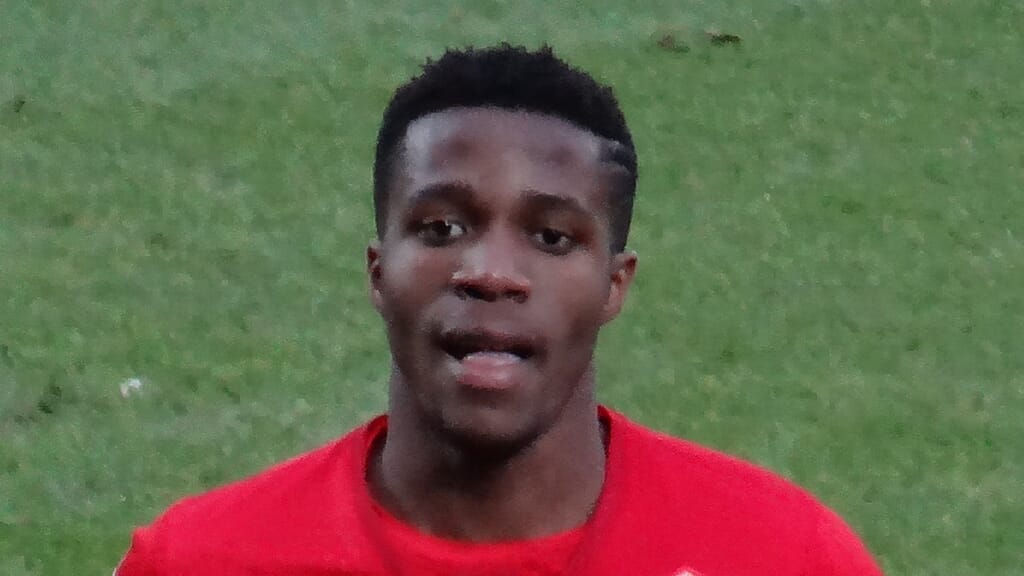 Wilfried Zaha working on his fashion designs, representing one of the hobbies of Premier League footballers.