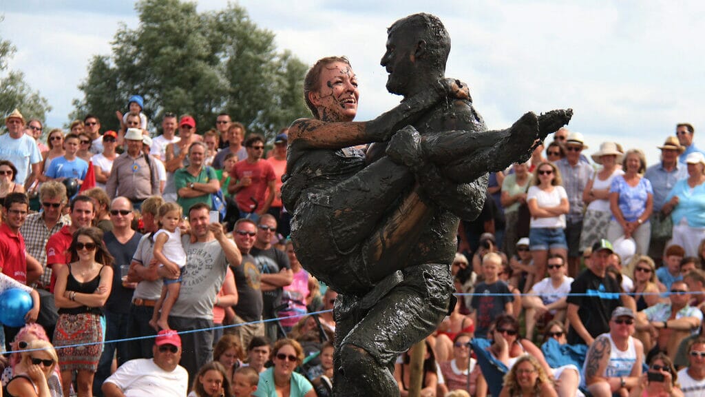 Competitor carrying their partner through an obstacle course during the annual UK wife carrying competition.