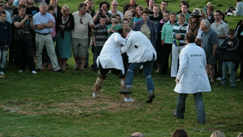 Participants in the shin kicking competition aiming to knock each other down by kicking their shins.