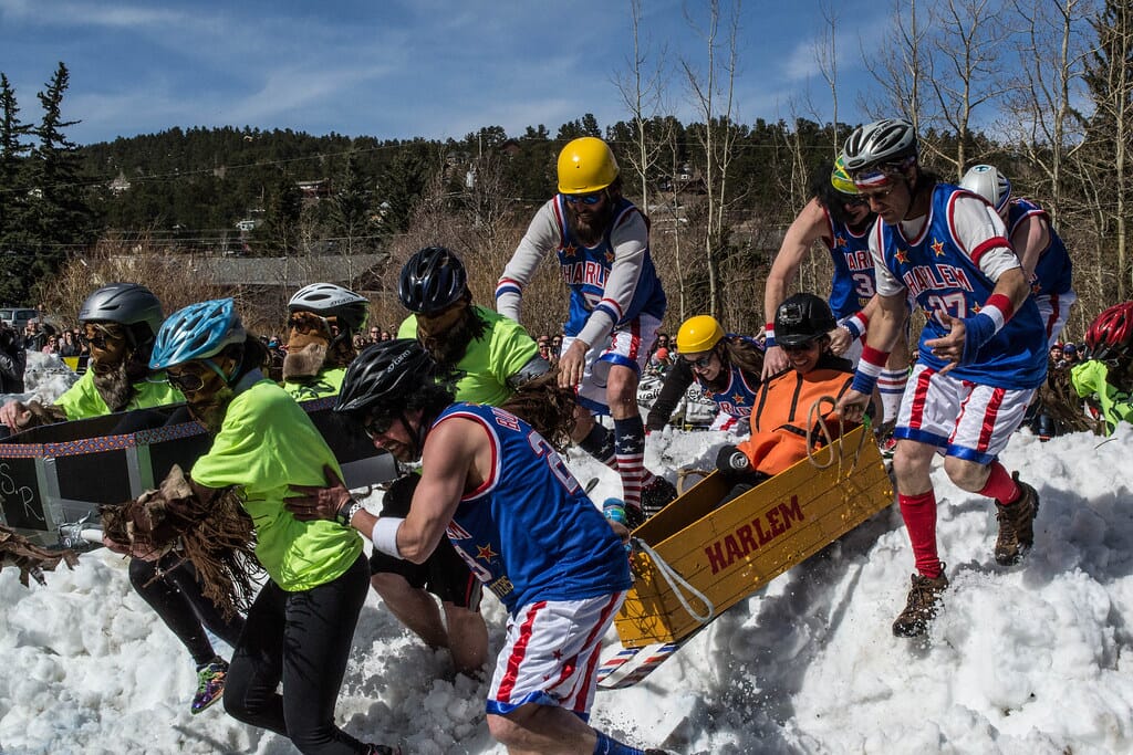 Teams carrying coffins in a race during Frozen Dead Guy Days, one of the strangest sports in the USA.