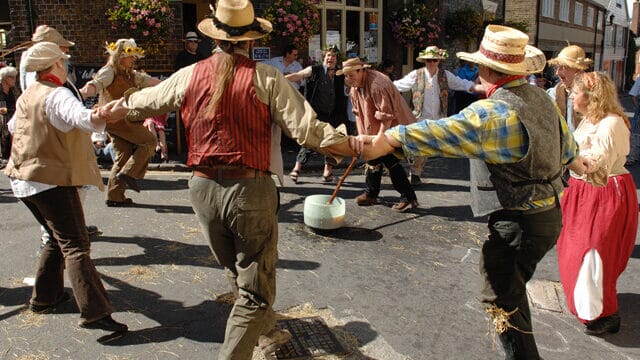 Participant spinning a beer-soaked cloth towards an opponent in the traditional game of Dwile Flonking.