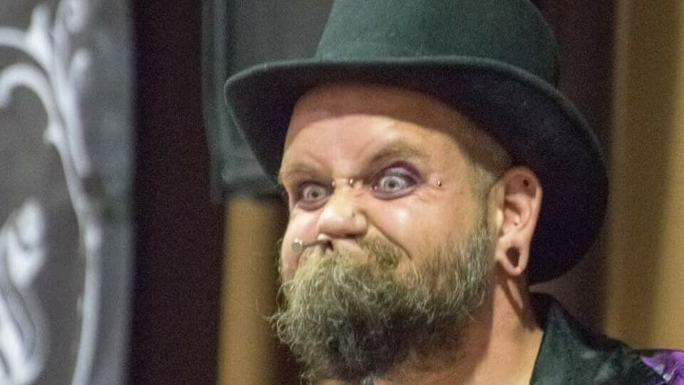 Contestant pulling a grotesque facial expression through a horse collar during the World Gurning Championship in Cumbria.