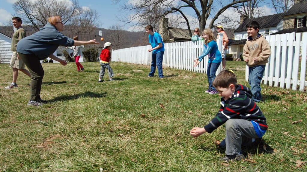 Team of two attempting to catch a raw egg without breaking it during an egg throwing competition.