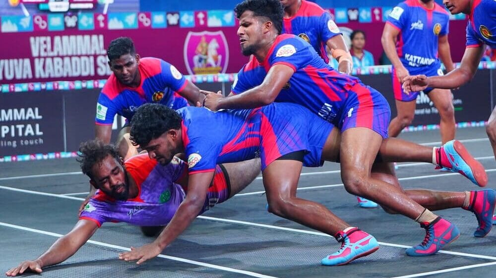 Players competing in an intense Kabaddi match, showcasing the mix of tag and wrestling in this forgotten sport.