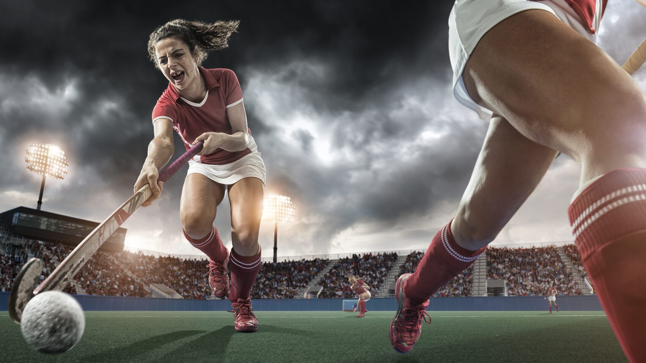 Field hockey players in action on a turf field, representing one of the biggest sports in the world.