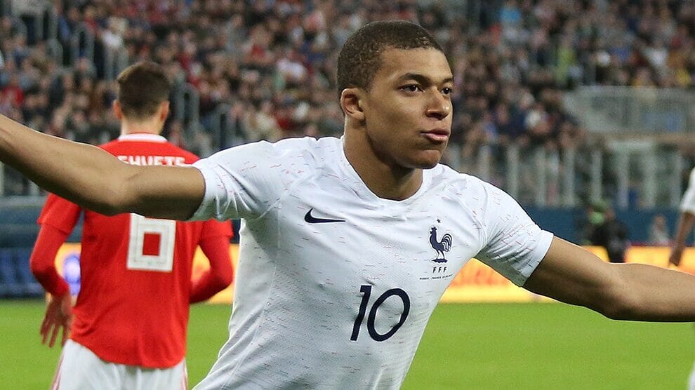 Image of Kylian Mbappé celebrating a goal for PSG, one of the highest paid footballers with a £1.2m per week wage.