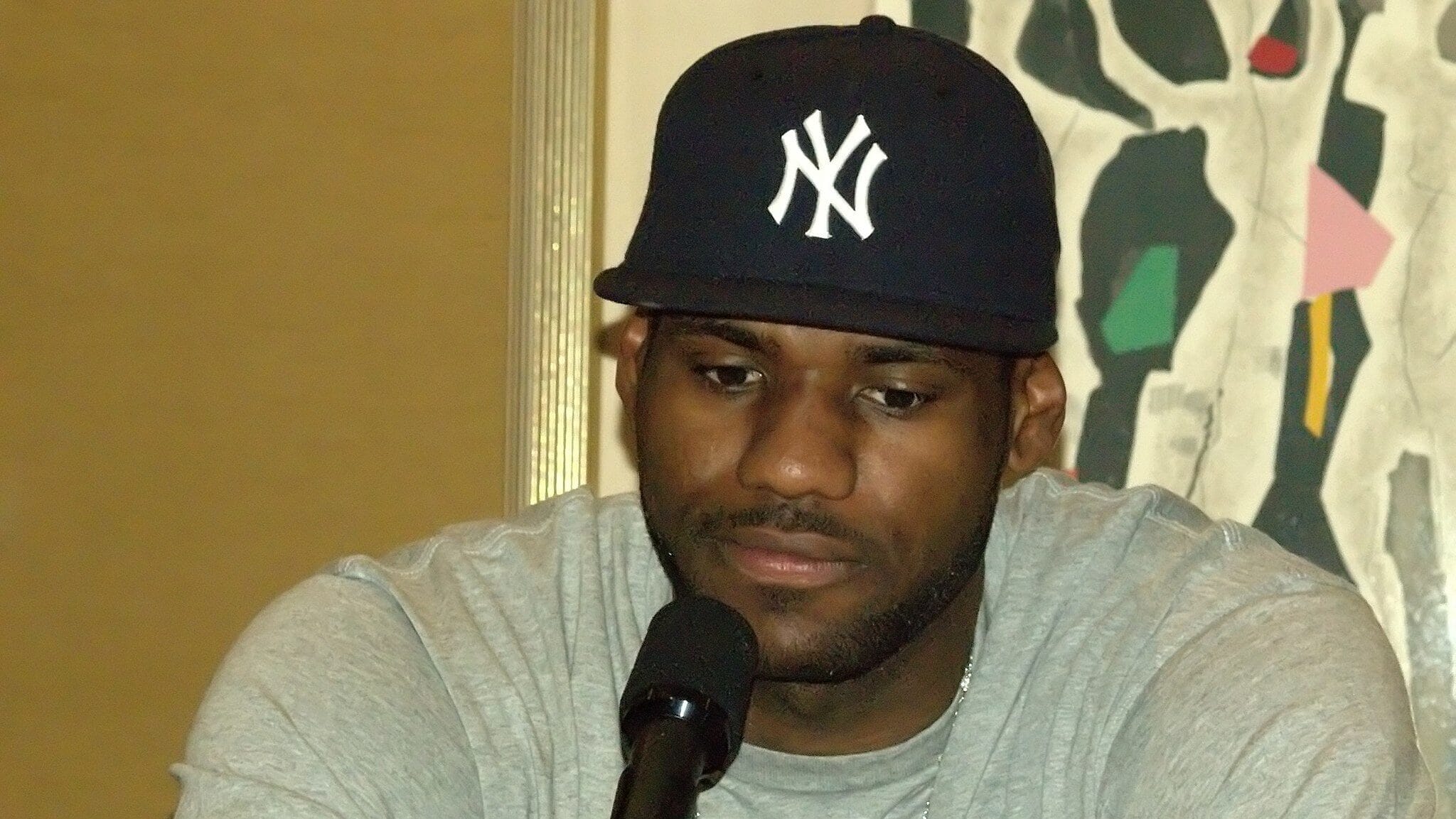LeBron James driving to the basket during an NBA game, embodying one of the greatest sporting figures in US history.