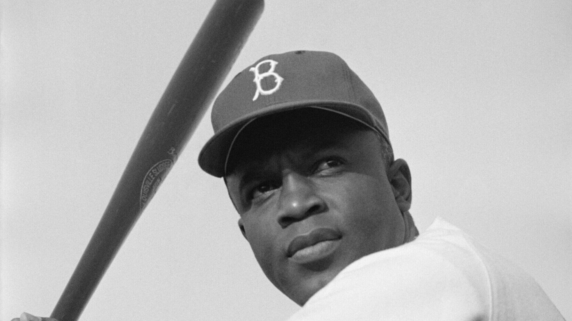 Jackie Robinson at bat for the Brooklyn Dodgers, breaking barriers as one of the greatest sporting figures in US history.