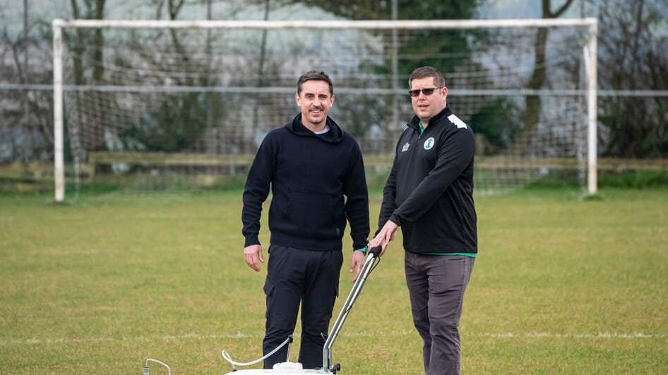 Gary Neville and Specsavers representative launching Best Worst Pitch football pitch improvements initiative.