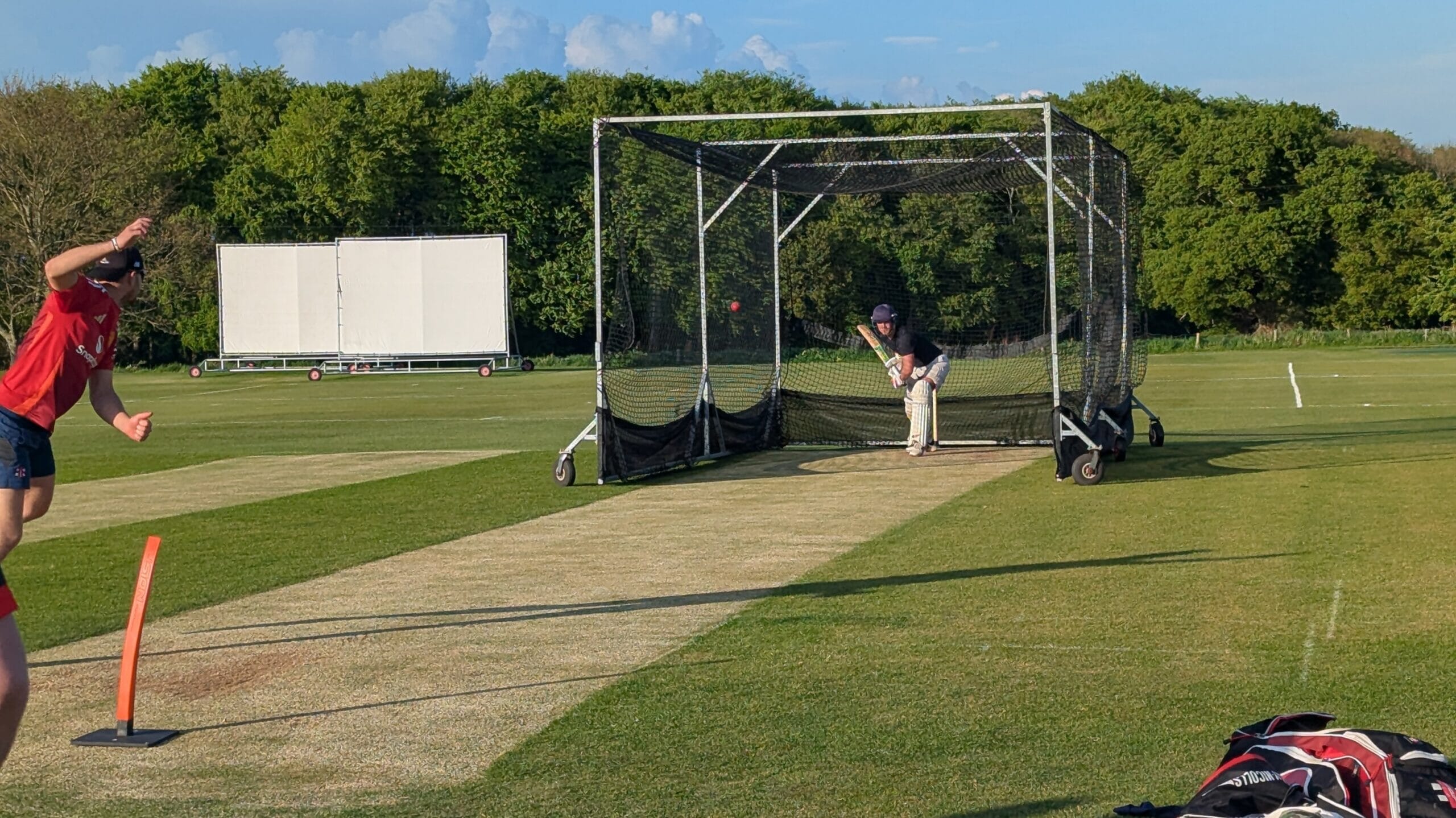 Junior and senior Bedale Cricket Club players in action during training, showing teamwork and communication through Spond