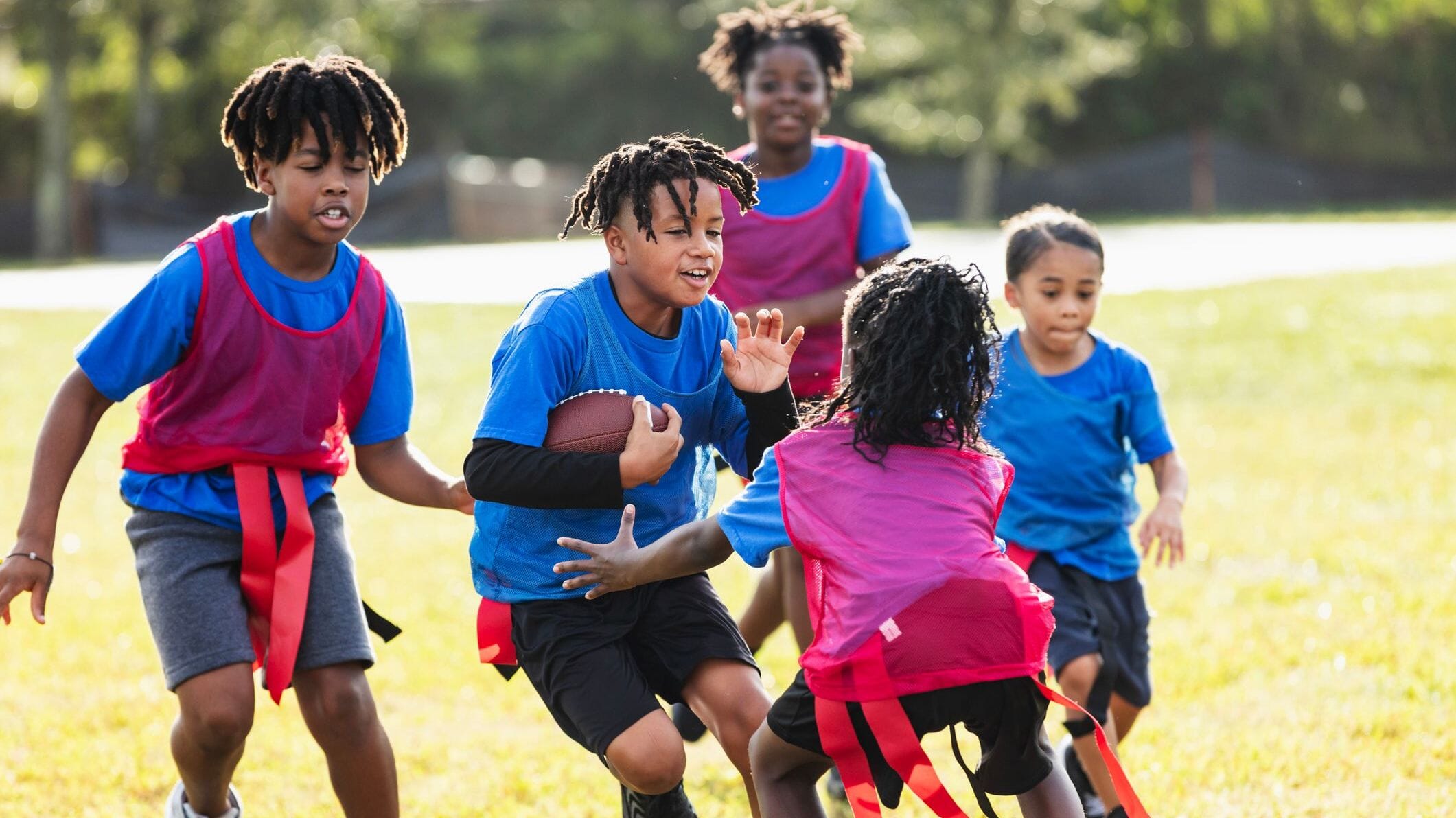 Fastest Growing Sports in the USA highlighted by a youth flag football game at a community sports field