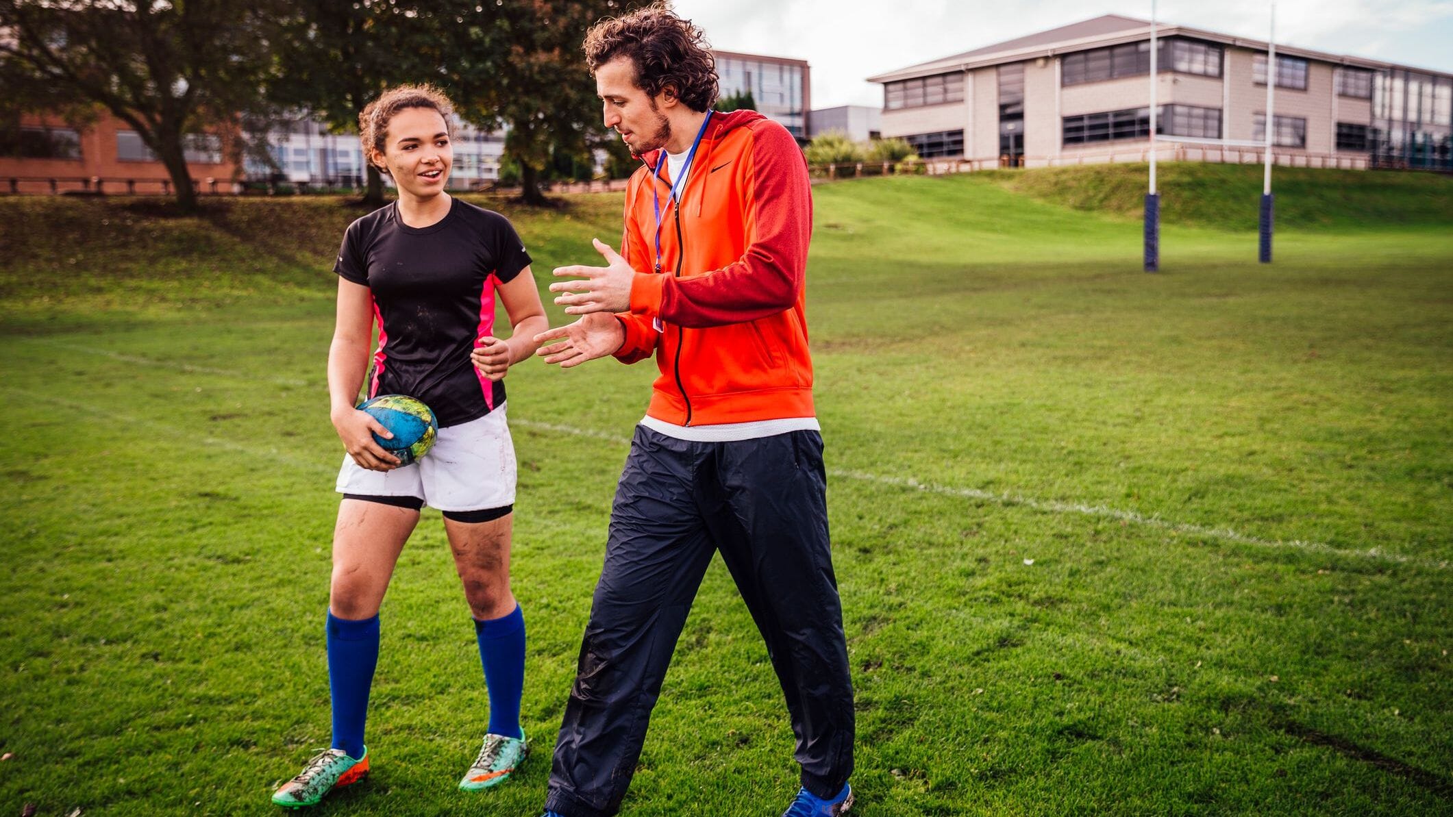 youth sports team management app on a phone at a soccer practice